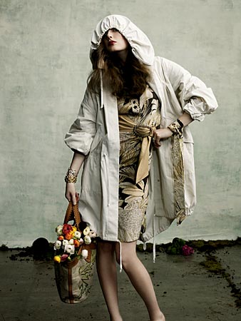 a woman poses in a coat and floral dress from Blake in Chicago