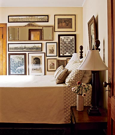 Sometimes serenity can be achieved with a well-edited dose of clutter, as this charming guest bedroom in a Chicago bungalow proves. Michael Crowley and Michael Jacobson covered a wall with old photos, vintage Vanity Fair prints, a wide mirror, and more. Muted tones and a traditional four-poster bed make this guest bedroom cozy.