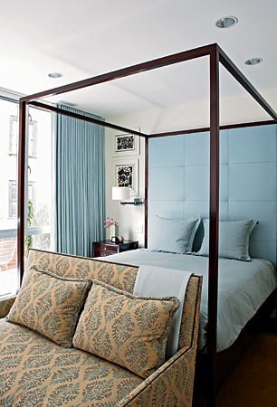 We love the character that designer Alex Jordan instilled in this otherwise restrained room when he put that Galbraith & Paul printed-linen loveseat at the foot of the bed. The backdrop of pale blue draperies, bed linens, and custom-made leather headboard is inviting in its own right.