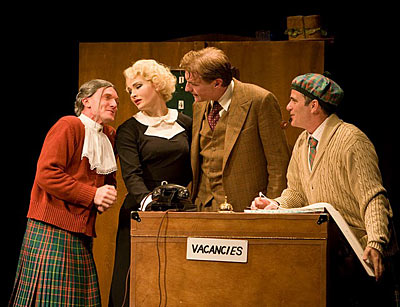 4 cast members of The 39 Steps standing around a podium