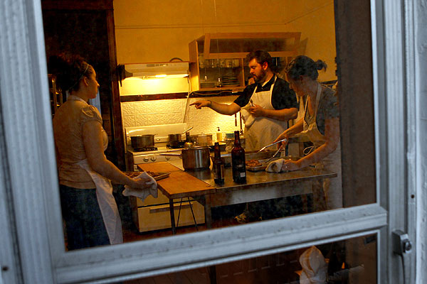 From left to right: Christine Cikowski, Josh Kulp, and Jenny Brown, a staffer, prep dinner in the kitchen