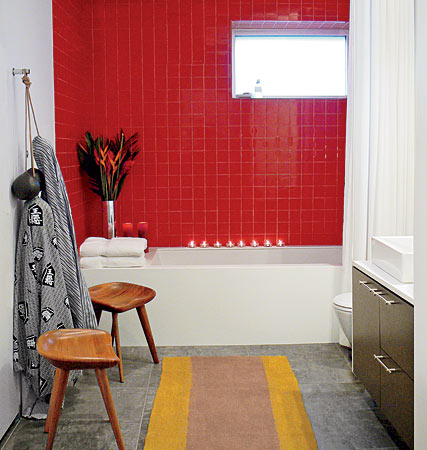 A bathroom accented with bright red tile