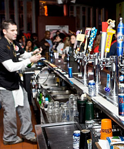 A line of beer taps at the bar at Risqué Café