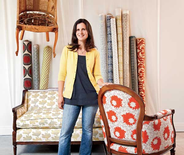 Wendy Kaplan poses with some of her fabric bolts and upholstered pieces