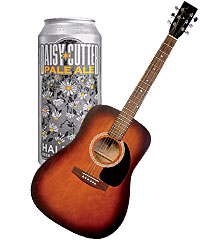 An acoustic guitar and a can of Daisy Cutter Pale Ale
