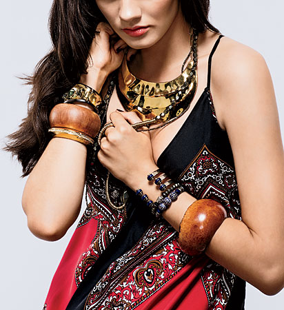 At left, from top: Gold- and gunmetal-plated cuff, Gillion Carrara silver-lined briarroot cuff, and gold-plated and crystal-encrusted bracelet. At right, from top: Pamela Love bronze and lapis cuff, Jolie Altman pavé diamond beaded bracelet, and enamel beaded bracelet, and Gillion Carrara briarroot and bark cuff. Necklaces: Gold-plated collar, and Jolie Altman bronze beaded wrap necklace