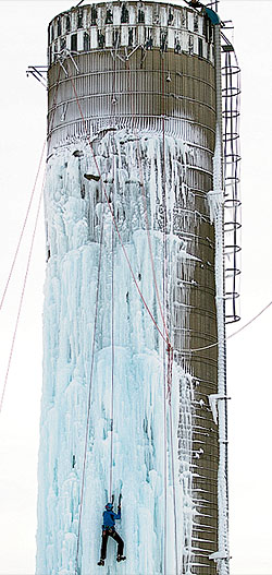 An ice climber scaling a frozen silo