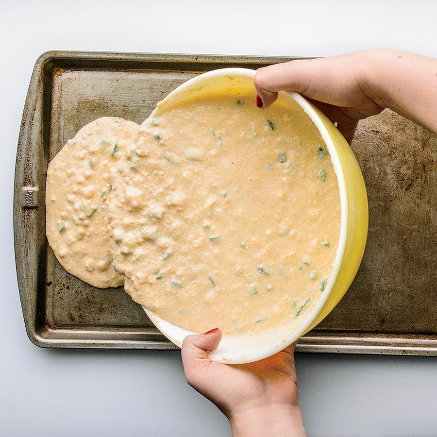 Cornbread mixture being poured into a baking pan