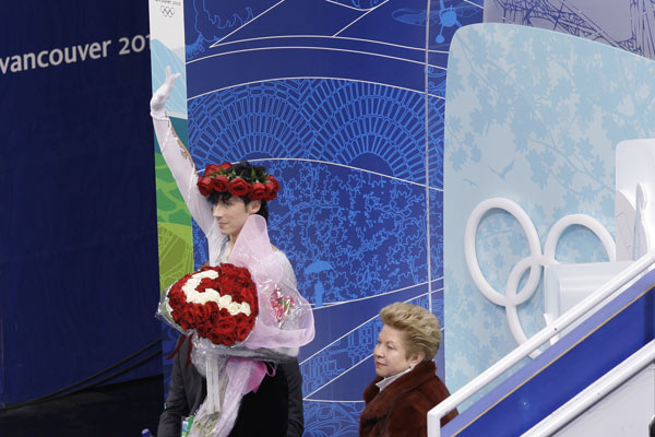 Johnny Weir, at the 2010 Vancouver Olympics, waves to the crowd after his long program