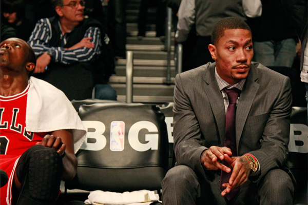 Chicago Bulls' Derrick Rose talks to teammates as he controls the ball  during the third quarter of an NBA basketball game against the New Jersey  Nets in Chicago, Wednesday, April 13, 2011.