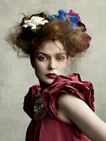 a woman poses in a floral dress from Ikram in Chicago