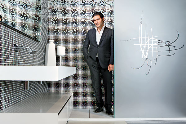 Luca Lanzetta stands in an Antonio Lupi shower with a frosted glass wall that cheekily depicts a finger drawing on a steamy surface (designs are customizable). The Lupi showroom opened in April.
