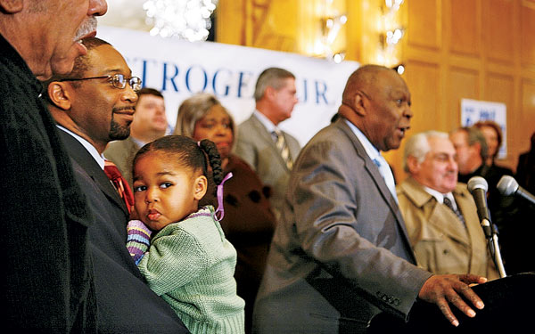 Todd Stroger (holding his daughter) looks on as John announces his bid for reelection in 2006