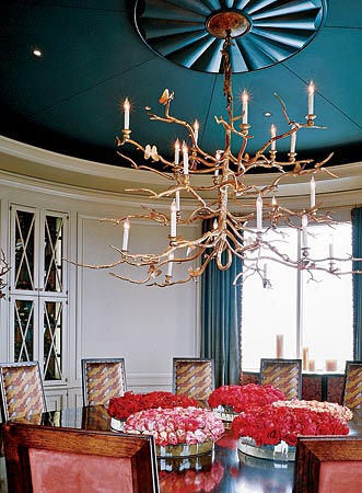 Deep color (Farrow & Ball’s Down Pipe) provides a dramatic backdrop for a chandelier and creates a sense of intimacy in a large dining room designed by Jessica Lagrange Interiors for a Lake Shore Drive residence.