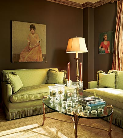 Chocolate brown and citrus-green make an elegant combination in this East Lake View condo. By going dark on the walls, the owner created instant intimacy. What better continuation of this theme than two matching silk love seats and romantic vintage portraits on the walls?