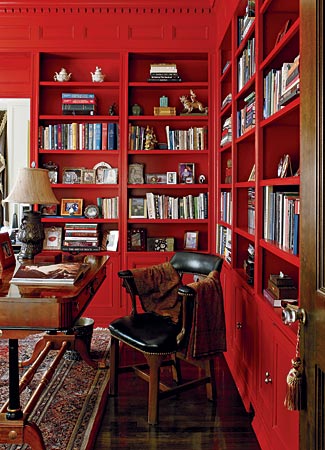 Interior decorator Blaine Johnson of JP Interiors chose floor-to-ceiling red (Benjamin Moore Poppy) for a library in a Beaux Arts condo on Astor Street. The effect is both dramatic and classic. It also deflects the visual cacophony of all the objects on the shelves.