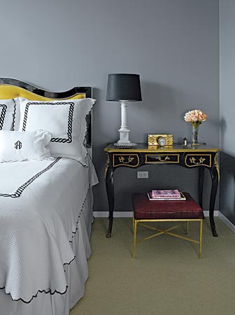 Interior designer Sasha Adler of Nate Berkus Associates used color to modernize what could have been a very traditional grouping of furniture in the bedroom of her River North condo. A yellow velvet headboard replaced a drab one; black lacquer updated an 18th-century writing table, and gray walls (Benjamin Moore Whale Gray) provided a crisp, clean background.
