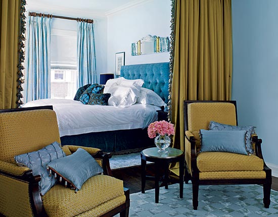 Blue and gold is a classic combination; here (in the same home as the red library), the soothing colors, repeated in various tones and textures, create a cohesiveness throughout the bedroom.