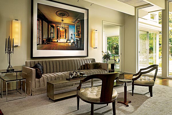 A photograph taken by Michael Eastman in Charleston, South Carolina, hangs over a TG Couture sofa in the living room. “I bought the photo before the house was ready,” the husband says, and designer Gary Lee kept the piece in mind when planning the living room. A cast-bronze sculpture by Fernando Botero reclines on the coffee table.