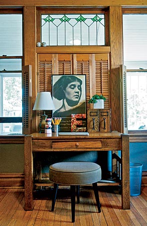 Pushing a desk in front of closed shutters created a focal point in the study; replacing a chair with a stool lightened the mood.