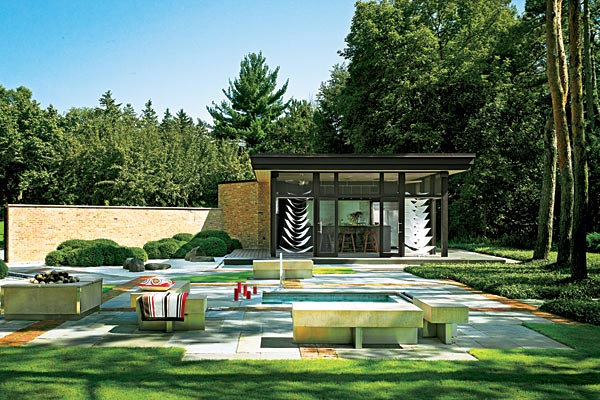 The four-acre property includes seven gardens, three of which have Asian elements, including the pavilion shown here. The garden styles are visually united through the use of boxwoods in different forms and a brick pattern in the bluestone pavement.