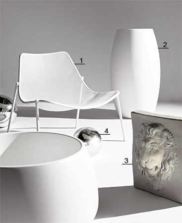 Tubular steel mesh lounge chair, molded polyethylene planters, lion mask, and mirrored-glass gazing globes