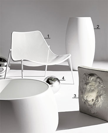 Tubular steel mesh lounge chair, molded polyethylene planters, lion mask, and mirrored-glass gazing globes
