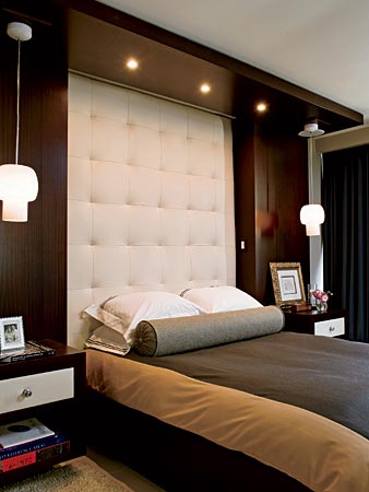 In a bedroom where space was tight and the ceiling was low, designer James Dolenc used a sophisticated tufted-leather headboard and pendant lights instead of table lamps to draw the eye upward.