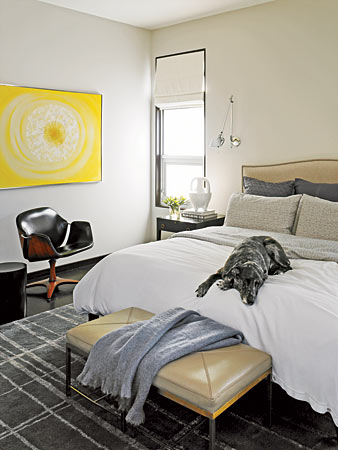 The key to making this room by Hudson Home appealing? Texture—from the mohair throw and the leather-and-wood Eames-era chair to the stainless steel swing lamp and the glossy black-lacquered night table. Add a splash of sunshine (here, in a cheerful yellow painting) and you’re done.