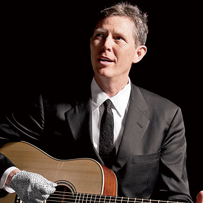Robbie Fulk playing an acoustic guitar