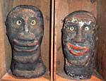 A pair of caricatured sculpted heads