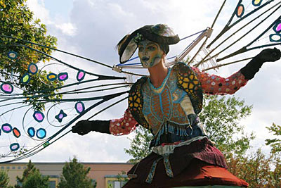 A colorfully costumed, winged performer from Dragon Knights