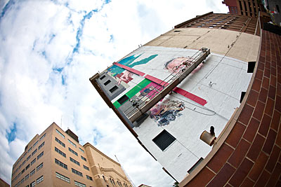 An overcast sky over a large, unfinished mural in Grand Rapids, Michigan