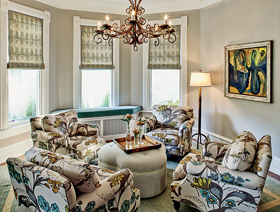 A sitting room, decorated with furniture featuring large floral prints