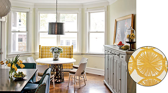 A kitchen decorated in light colors, which includes a banquette with Mokum fabric