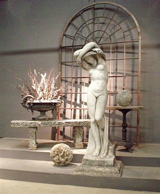 A statue of a woman disrobing