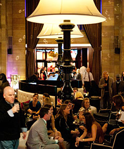 Oversized lamps loom over patrons at the Living Room Bar