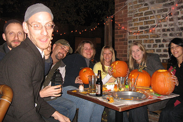 Patrons drinking and carving pumpkins