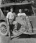 A 1925 picture of Oscar Isberian (right) and his brother Megerditch, displaying one of their prized rugs