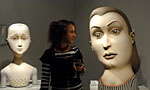 A patron admiring large bust sculptures