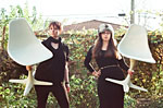 Two models holding chairs from Vintage Bazaar