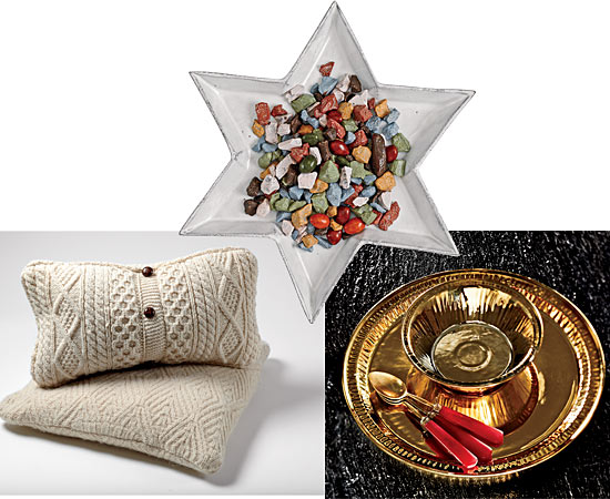 Clockwise from top: Milk chocolate rocks on a star-shaped Etoile dessert plate, Seletti gold-glazed porcelain bowl and dinner plate, vintage brass spoons with red Bakelite handles, and reclaimed Irish sweater pillows.