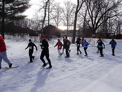 Snowshoers racing down a trail