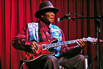 David Honeyboy Edwards playing a guitar