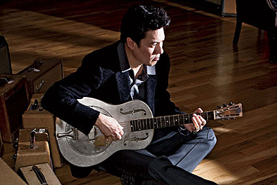 Todd Park Mohr strums a vintage guitar at Chicago Music Exchange in Roscoe Village