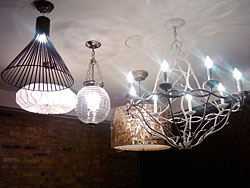 A variety of chandeliers in the women's restroom