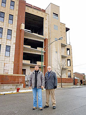 Jim Collins and Lewis Korompilas standing in front of the soon-to-be-rehabbed building on West Belmont Avenue
