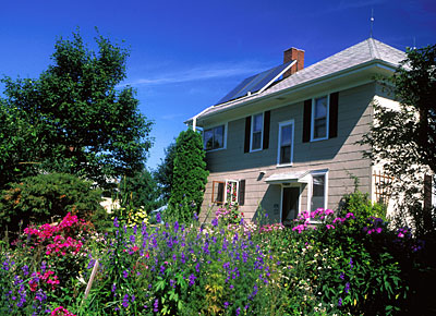 A house surrounded by colorful flowers