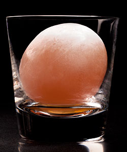 A drink with a liquor-injected egg of ice at Aviary