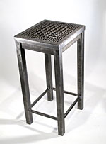 A tall metal table by Riggs Barr